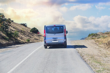 Minivan Drives up the Mountain Road