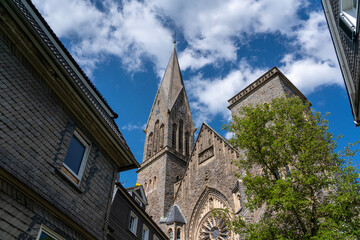 The historic St. Martinus Church in Olpe, Germany, built in neo-Gothic style, features a striking 61-meter tower and intricate architectural details, standing as a cultural landmark.