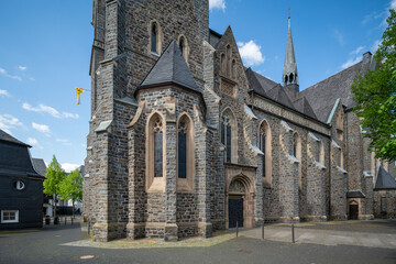 The historic St. Martinus Church in Olpe, Germany, built in neo-Gothic style, features a striking 61-meter tower and intricate architectural details, standing as a cultural landmark.