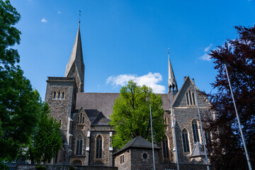 The historic St. Martinus Church in Olpe, Germany, built in neo-Gothic style, features a striking 61-meter tower and intricate architectural details, standing as a cultural landmark.