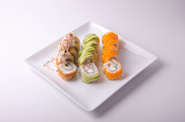 rolls with salmon, avocado and cheese on a white plate Japanese food