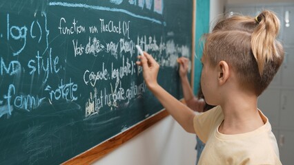 Diverse student studying coding engineering prompt while writing answer on blackboard. Intelligence children planning and learning about coding development plan. Successful boy sharing idea. Pedagogy.