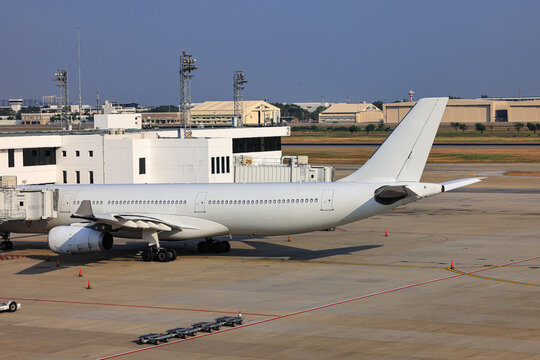 The white commercial airplane on process of Pre-flight service and handling at International Airport.