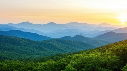 Fototapeta premium A serene landscape showing rolling mountains bathed in soft sunlight, with lush green trees in the foreground and a hazy skyline in the background.
