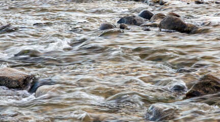 A small stream in the forest in slow motion in the South Island, New Zealand