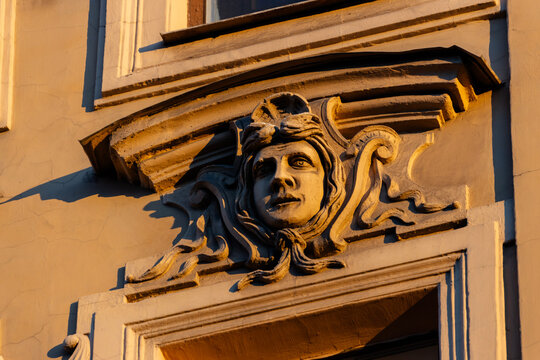 The architectural element mascaron on the facade of a house in St. Petersburg