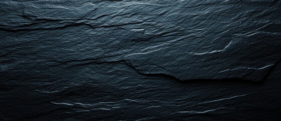 Black obsidian texture with sharp edges, glassy surface and light reflections, rock texture, volcanic origin and mystical stone material