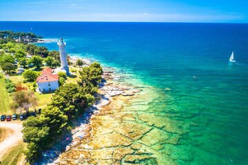 Croatia. Savudrija lighthouse and turquoise crystal clear rocky beach aerial view