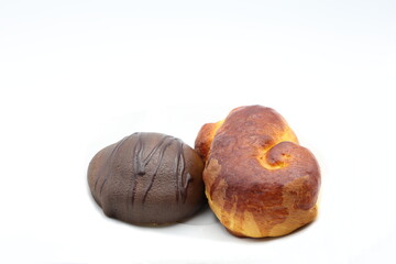 Swedish chocolate pastry called biskvi and lussebulle. Close up and isolated with a white background.