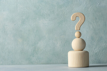 Wooden question mark on a light wood pedestal against a teal textured background, showcasing a concept of inquiry or uncertainty, ideal for  blog or website banner
