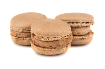 Three brown macaron cookies