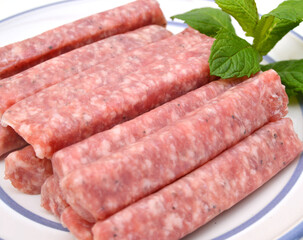 Raw meat sausages isolated on white background 
