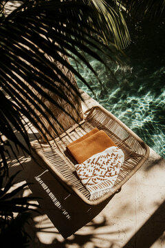 Tropical Poolside Relaxation with Sun Lounger and Palm Shadows