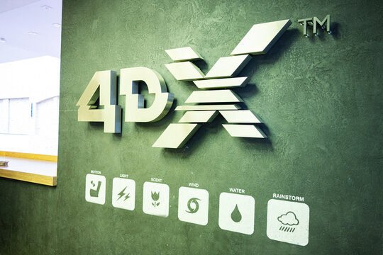 4DX logo with motion and effects symbols displayed on textured green wall