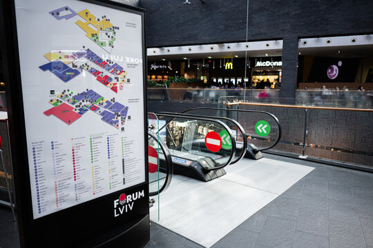 Interior view of Forum Lviv shopping mall with store map and escalator