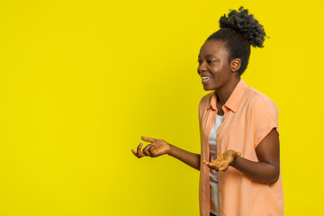African American woman turns to side, imitating a dialogue with imaginary people, using gestures....