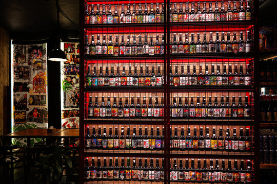 Wall Display of Craft Beer Pravda Bottles in Modern Bar Interior