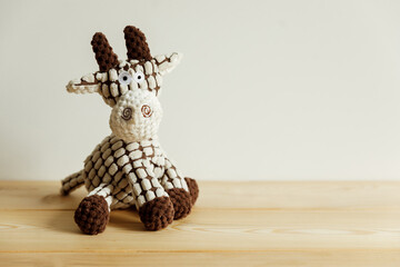 A cute stuffed giraffe, a stuffed toy on a light, simple background.