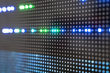 Fototapeta premium Close-up of led display pattern with vibrant blue and green lights.