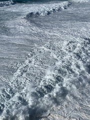 Powerful ocean waves crashing ashore, symbolizing nature's raw power and freedom, perfect for World...