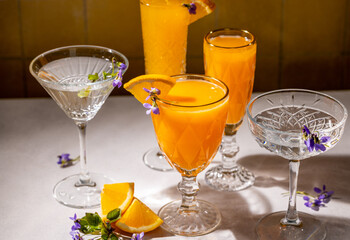 Elegant crystal glasses with refreshing orange juice and garnishes