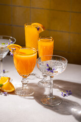 Refreshing orange cocktails garnished with edible flowers and orange slices