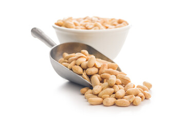 Roasted salted peanuts in scoop isolated on white background.