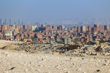 View from the pyramid complex in Giza, Egypt, to the high-rise apartment buildings and developments...