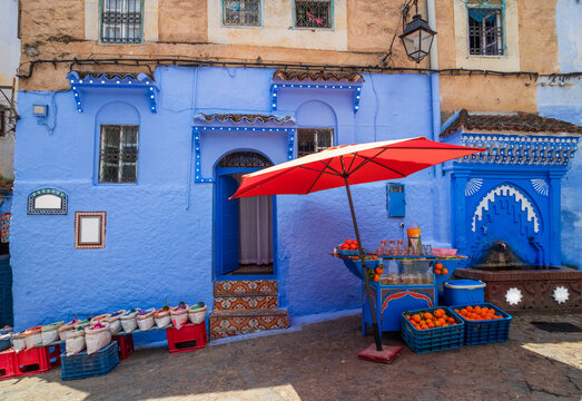 Blue traditional house in Plaza Kenitra, Morocco &ndash; vibrant square with local spice and fresh orange juice shop