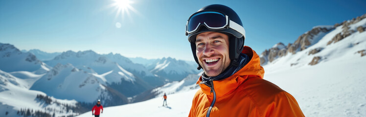 Smiling young man in ski helmet portrait against snowy mountain landscape. Winter sport skiing on sunny day. Active lifestyle in winter holidays. Man enjoys fresh air at winter resort.