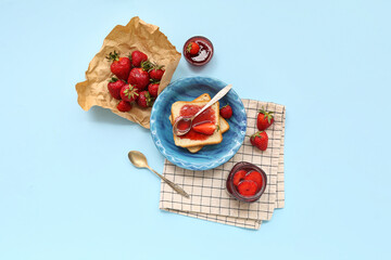 Plate of sweet toasts with strawberry jam and fresh berries on blue background