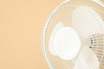 Modern electric fan on beige background