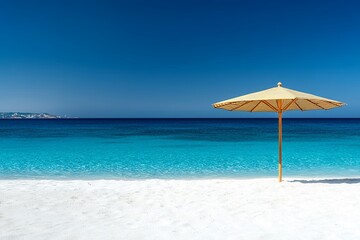 Serene beach scene with blue ocean and bamboo parasol on white sand