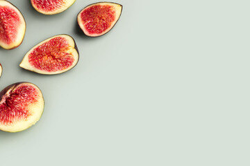 Cut fresh figs on green background