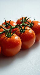Freshly harvested tomatoes on a countertop glistening with moisture ready for cooking