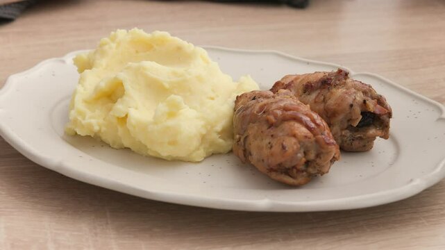 cook show roasted chicken meat rolls on plate with nashed potatoes, making delicious healthy meal, food closeup