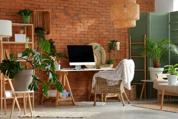 Interior of office with workplace and green plants