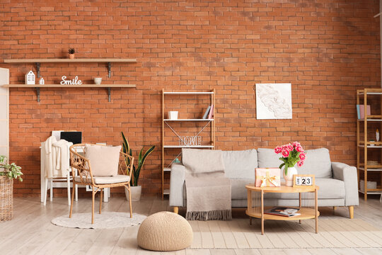 Interior of modern living room with flowers, gift box and calendar on coffee table in living room