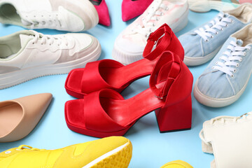 Ankle strap open toe shoes among other shoes on blue background