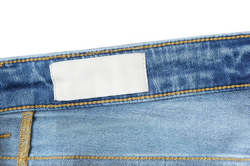 Clothing label inside jeans on white background. Close up. Denim jeans and fabric tag label mockup...