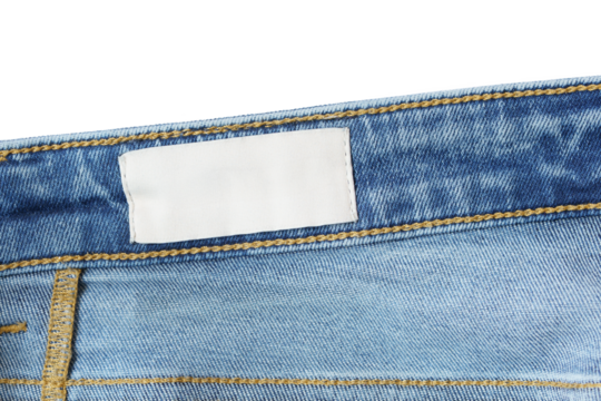 Clothing label inside jeans on white background. Close up. Denim jeans and fabric tag label mockup suitable for showcasing brand identity and product details.