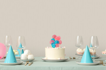 Cake with sweets and dishes for birthday party on table against white wall