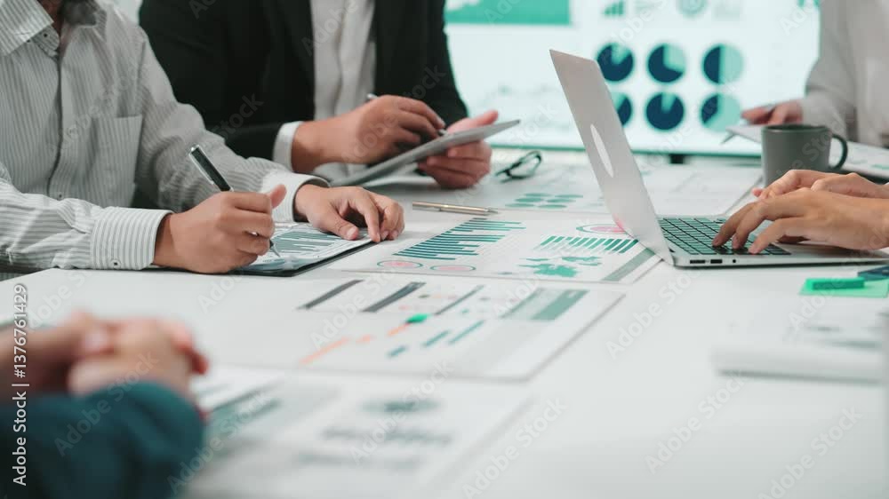 Poster a dynamic business team engages in collaborative discussions, analyzing charts and graphs on tablets