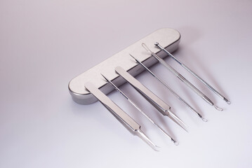 facial skin cleaning tool set with metal box on white background