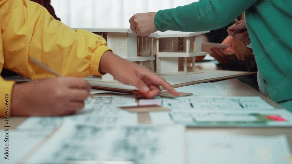Poster a lively architecture studio scene showing a diverse team discussing plans while examining an intric
