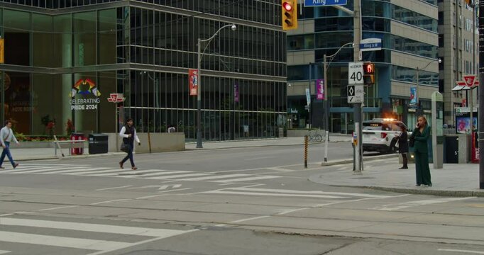 Beautiful Summer Day In Toronto, Showing A Busy Intersection With Cars, Streetcars, And Pedestrians Crossing. The Scene Captures The Urban Vibe Of This Bustling Metropolis Surrounded By Skyscrapers. 