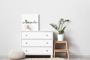 Interior of living room with white commode, stool and pouf