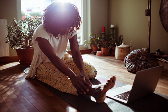 Young woman doing yoga at home