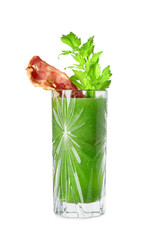 Glass of green bloody mary cocktail with celery and bacon on white background