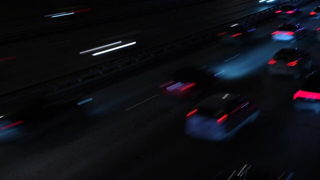 Сinematic shot of highway traffic at night, captured with a slow shutter speed